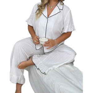 Women's two-piece white short sleeve pajama set with ruffled edges and black piping