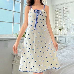 Detail of white spaghetti strap nightdress with blue heart print and bow tie accent