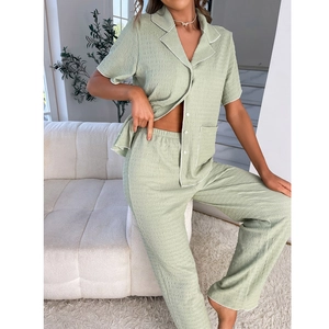 Women's sage green short sleeve pajama set with textured fabric and white piping