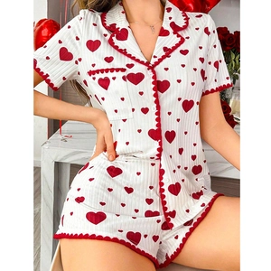 Women's two-piece heart print pajama set with short sleeves and red wavy trim details