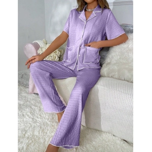 Detail of purple pajama set with waffle texture fabric and contrast white piping trims