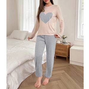 Women's two-piece heart print pajamas set with pink long-sleeved top and grey ribbed pants