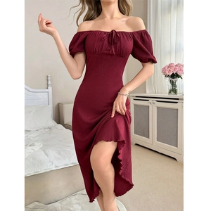 Close-up of wine red off-shoulder dress with textured fabric and ribbon bow detail