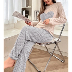 Detail of soft knitted lounge set featuring heart patch and vertical ribbed texture