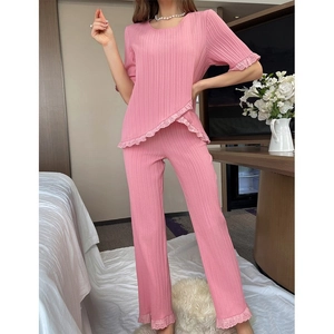 Detailed view of pink ribbed pajama set with lace trim and asymmetrical hem design