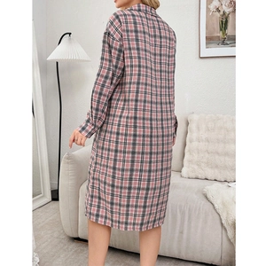 Pink and grey plaid long sleeve pajama dress for women in a comfortable home setting
