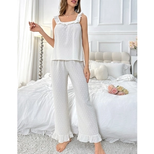 Detail of white Swiss Dot pajama set showing delicate ruffle trims and texture