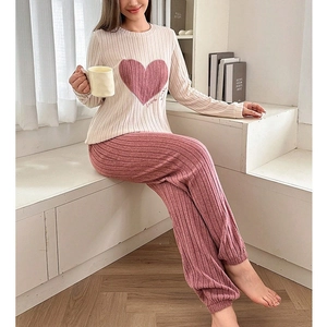 Detail view of heart print long sleeve top and matching pink trousers loungewear set