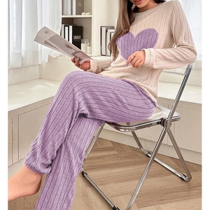 Detail of contrast heart pajama set featuring textured knit fabric in beige and purple