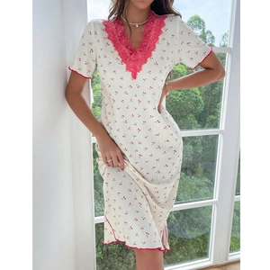 Detail of white cotton lounge dress featuring cherry prints and pink lace V-neckline