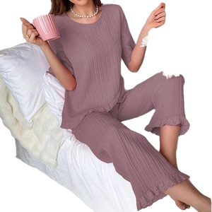 Women's pleated two-piece pajama set with lace edges in dusty pink short sleeve design