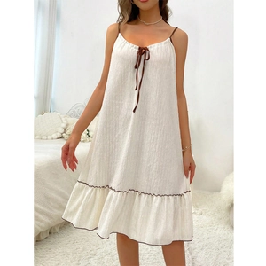 White sleeveless spaghetti strap nightgown with brown bow and ruffled hem for summer