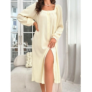 Detail of cream long-sleeve dress with square neck, button front and side slit detail