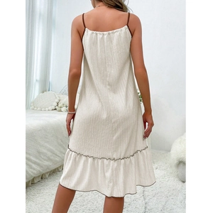 Back view of a cream spaghetti strap lounge dress with a pleated ruffled hemline