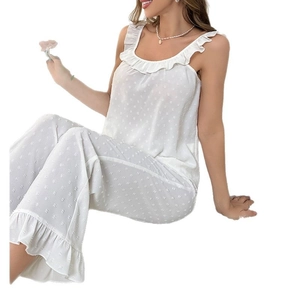 Elegant white two-piece pajama set with polka dot texture and lace ruffle details