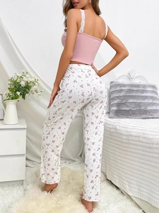 Detail view of pink lace camisole back and floral printed pajama trousers on model