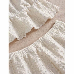 Sleeveless cream pajama set with seersucker texture and lace trim detail for summer