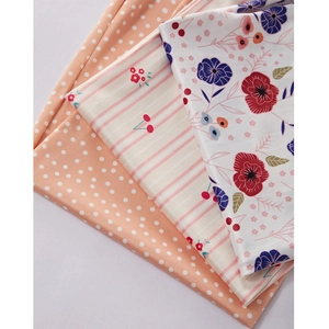 Detailed view of floral, polka dot, and cherry print fabric patterns for pajama sets