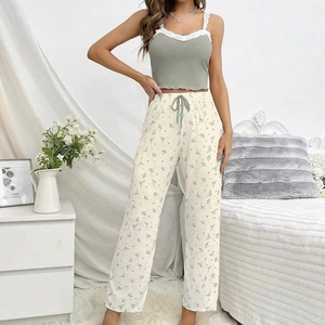 Detail view of floral pajama set with lace trim top and sage green printed trousers