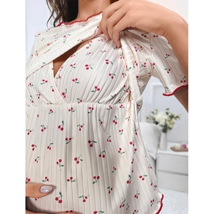 Nursing pajamas with cherry print and layered opening for breastfeeding in white