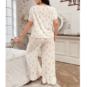 Women's pajama set featuring pink floral print on white fabric with ruffled leg hems