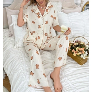 Women's pajama set featuring short sleeve button-up top and long pants with bear prints