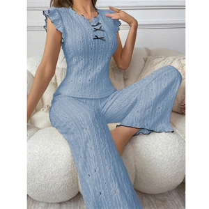 Elegant light blue women's pajama set with lace bow design and hollowed-out fabric