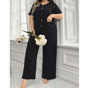 Close-up of black short-sleeve pajama set with white buttons and wide-leg trousers