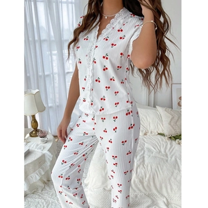 Close-up of white cherry print pajama set featuring V-neck lace trim and ribbed texture fabric