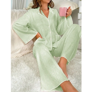Detail of light green pleated pajama set featuring soft textured fabric and buttoned collar