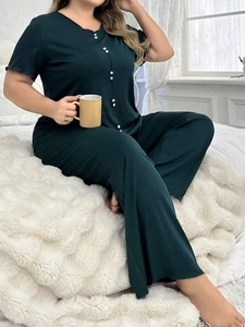 Detail of dark green plus size pajama set featuring soft fabric and buttoned short sleeves