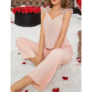 Elegant two-piece pink silk pajamas set with lace trim and pearls for women