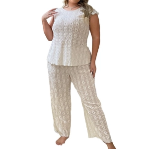 White two-piece loungewear set featuring floral hollow-out texture and wide-leg trousers