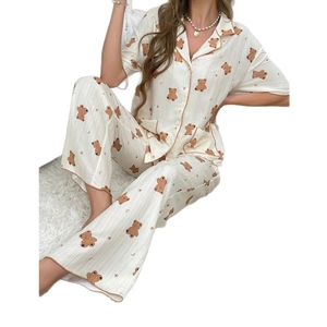 Women pajama set with short sleeve top and long pants featuring brown cartoon bear patterns