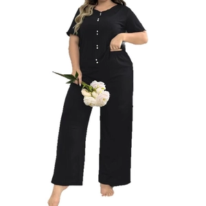 Women's black two-piece lounge set with short sleeve button-up top and wide leg pants