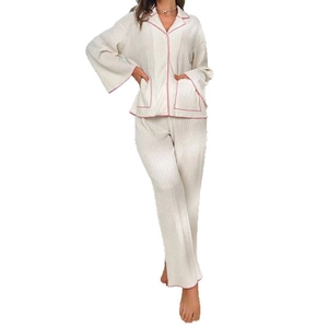 Two-piece pleated loungewear set with long sleeve button-up top and pink contrast piping