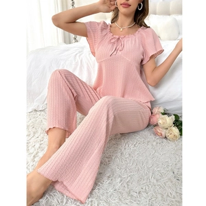 Pink women's pajamas set with short sleeve top and pants featuring ribbed texture