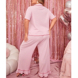 Pink oversized pajamas set for women with textured fabric and red piping trim