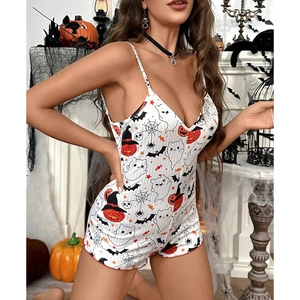 Close-up of rib-knit fabric with Halloween pumpkin, ghost, and bat patterns on white romper