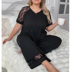 Close-up of black plus size loungewear set featuring intricate floral lace details