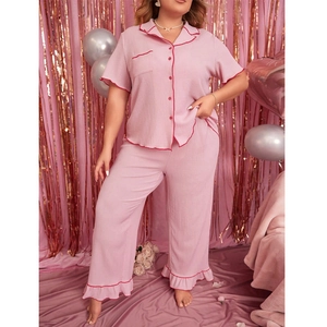 Pink oversized short sleeve pajama set with red wavy trim and matching pants