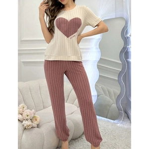 Detail of heart print and love embroidery on striped short-sleeve pajama top