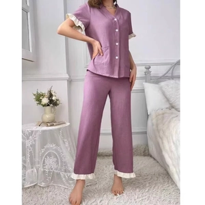 Women's lavender short sleeve pajama set with contrast ruffles and button-down front