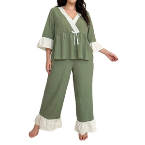 Green two-piece women's pajama set with V-neck lace trim and wide-leg pants