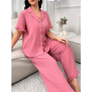 Plus size peach pink pajama set with short sleeve button-down top and lace-trimmed pants