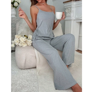 Detail of grey ribbed knit loungewear set featuring side tie-up bow on camisole top