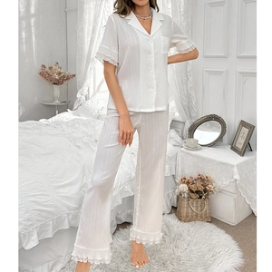 Women's white two-piece pajama set with lapel shirt, ruffled sleeves, and long pants