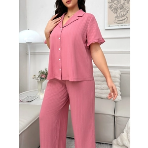 Detail view of pink short sleeve pajama top with hollow lace cuffs and ribbed texture