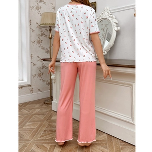 Women's floral pajama set with pink rose print top and matching pants in cozy knit fabric