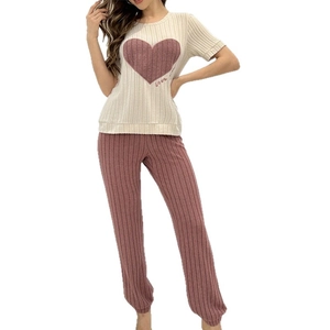 Women's pajama set featuring a striped short-sleeve heart print top and long casual pants